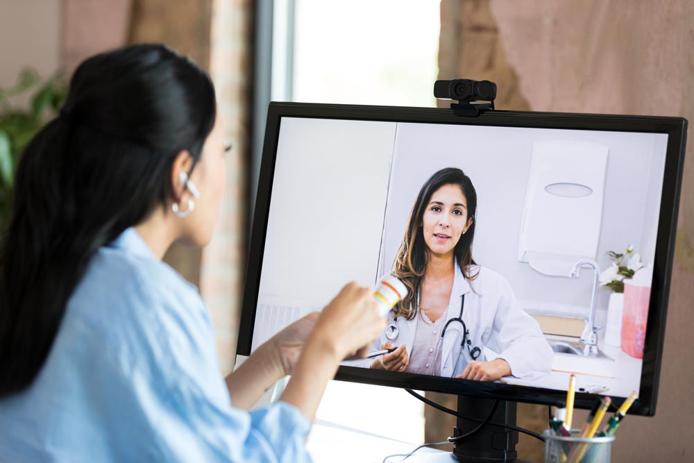 A woman doing telemedicine with her doctor.